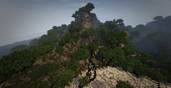 A view on a mountain peak which features a small lakeriver and feeds a larger lake behind the beach